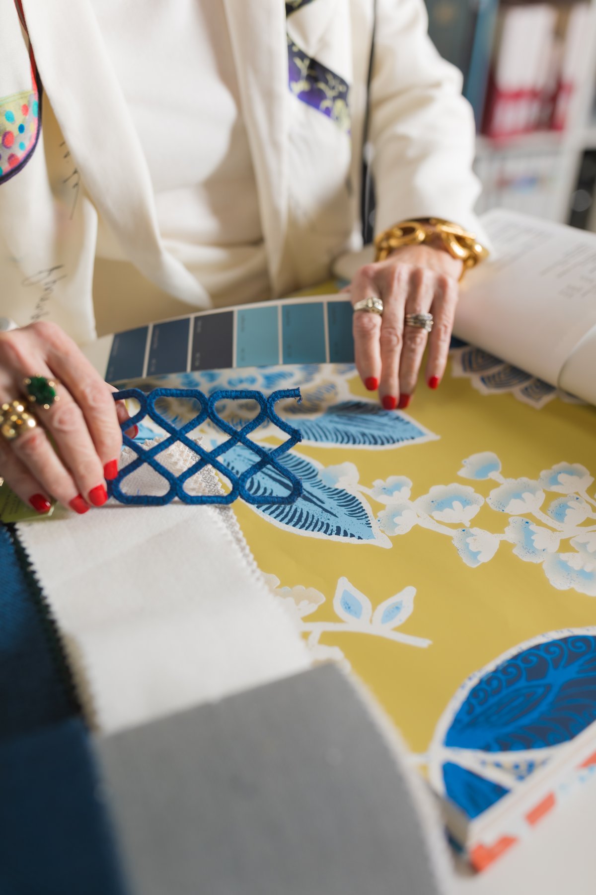 Designer selecting fabric swatches and paint colors for a room palette
